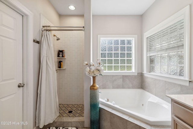 820 Jackeys Creek Ln SE, Leland, NC 28451 - bathroom featuring a tub with jets, a tile shower, and vanity