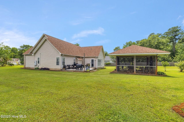 820 Jackeys Creek Ln SE, Leland, NC 28451 - back of property featuring a sunroom, a patio area, a yard, and a shingled roof
