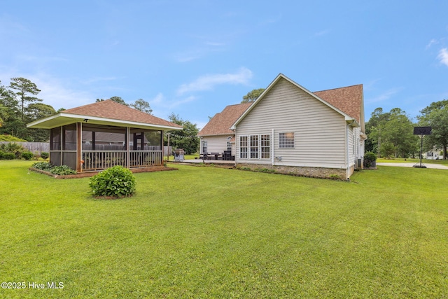 820 Jackeys Creek Ln SE, Leland, NC 28451 - back of house featuring a sunroom, a lawn, and a shingled roof