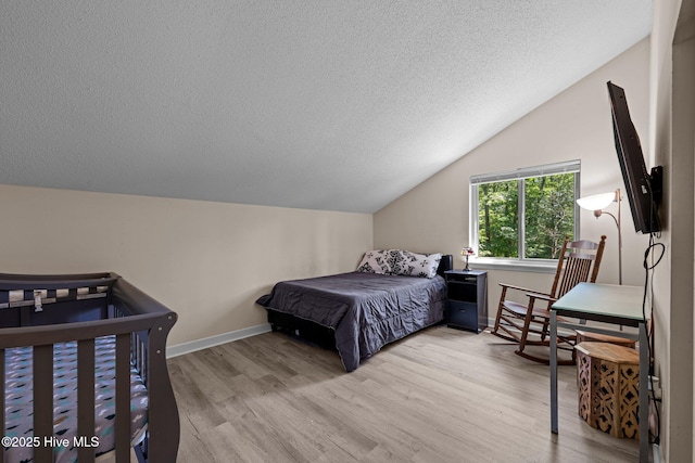 120 Croatan Ln, New Bern, NC 28562 - bedroom featuring vaulted ceiling, wood finished floors, and a textured ceiling
