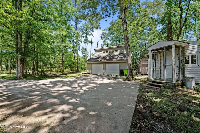 120 Croatan Ln, New Bern, NC 28562 - view of front facade with an outbuilding, driveway, and an attached garage