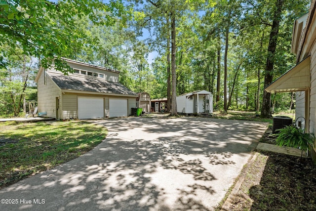 120 Croatan Ln, New Bern, NC 28562 - exterior space with a storage shed, concrete driveway, and roof with shingles