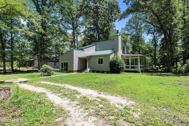 120 Croatan Ln, New Bern, NC 28562 - back of house with a sunroom, a lawn, dirt driveway, and a chimney