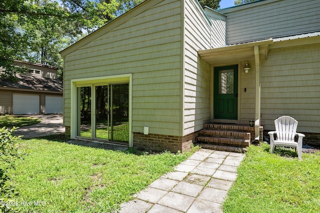120 Croatan Ln, New Bern, NC 28562 - view of exterior entry with a lawn and a garage