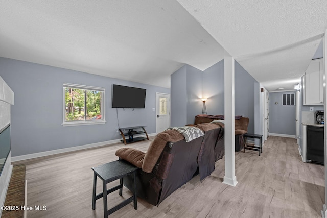 120 Croatan Ln, New Bern, NC 28562 - living area with light wood-style floors, a textured ceiling, and a fireplace