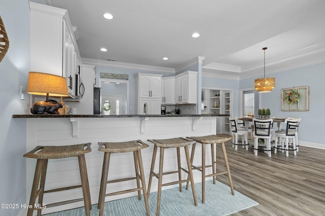 505 Davidson Dr, Newport, NC 28570 - kitchen featuring white cabinetry, crown molding, dark stone counters, recessed lighting, and a peninsula