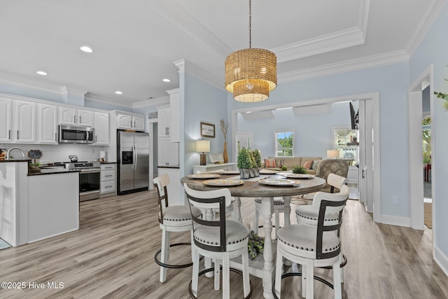 505 Davidson Dr, Newport, NC 28570 - dining area with light wood-type flooring, ornamental molding, a chandelier, and recessed lighting