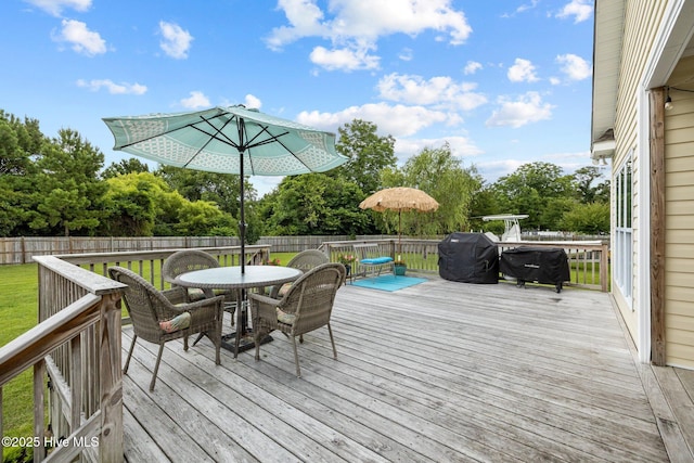 505 Davidson Dr, Newport, NC 28570 - deck featuring outdoor dining area, a fenced backyard, grilling area, and view of wooded area
