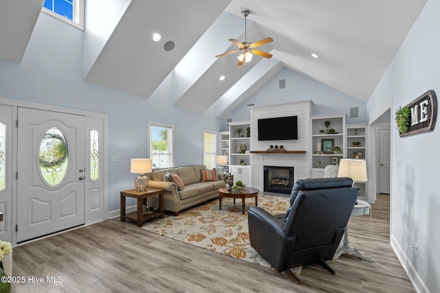 505 Davidson Dr, Newport, NC 28570 - living room featuring high vaulted ceiling, a ceiling fan, a large fireplace, wood finished floors, and a skylight