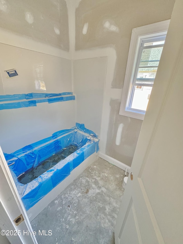 919 Albrittons Rd, Kinston, NC 28504 - full bath featuring unfinished concrete flooring and a bathtub