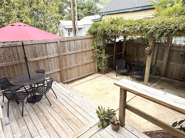 228 Mcrae St, Wilmington, NC 28401 - wooden deck with outdoor dining space, a fenced backyard, and a patio area