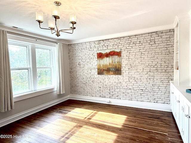 228 Mcrae St, Wilmington, NC 28401 - unfurnished dining area with a chandelier, crown molding, brick wall, and wood finished floors