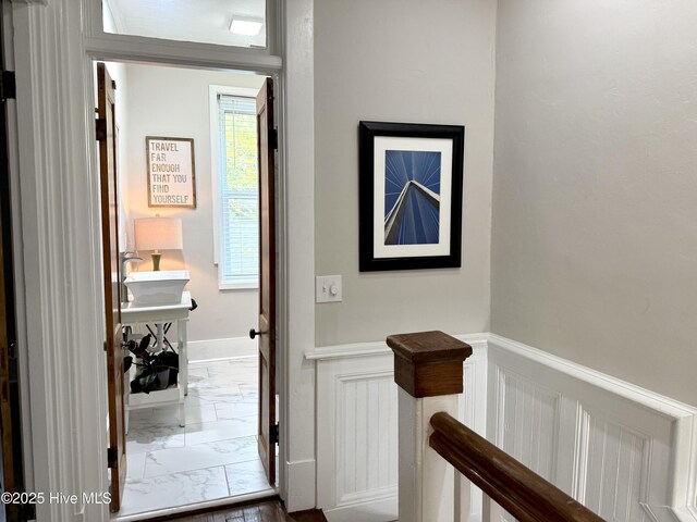 228 Mcrae St, Wilmington, NC 28401 - hallway with marble look tiles and a wainscoted wall