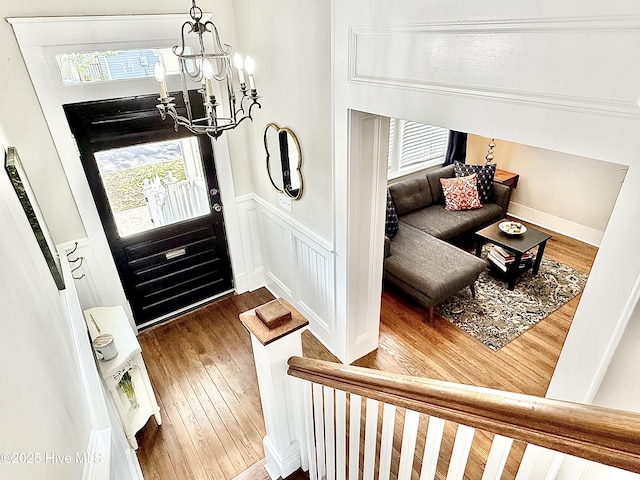 228 Mcrae St, Wilmington, NC 28401 - foyer with wood finished floors, a chandelier, and wainscoting