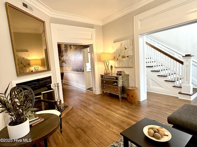 228 Mcrae St, Wilmington, NC 28401 - living area featuring stairway, wood finished floors, and crown molding