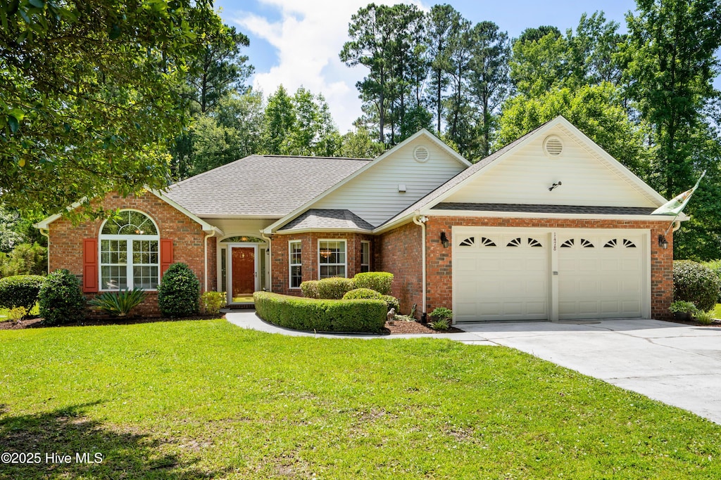 1478 Bluegil Dr, Longs, SC 29568 - view of front facade with a garage, driveway, a front yard, brick siding, and roof with shingles