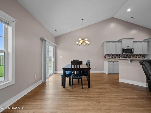 500 Perth Ct, Hubert, NC 28539 - dining space featuring a chandelier, high vaulted ceiling, light wood finished floors, and recessed lighting