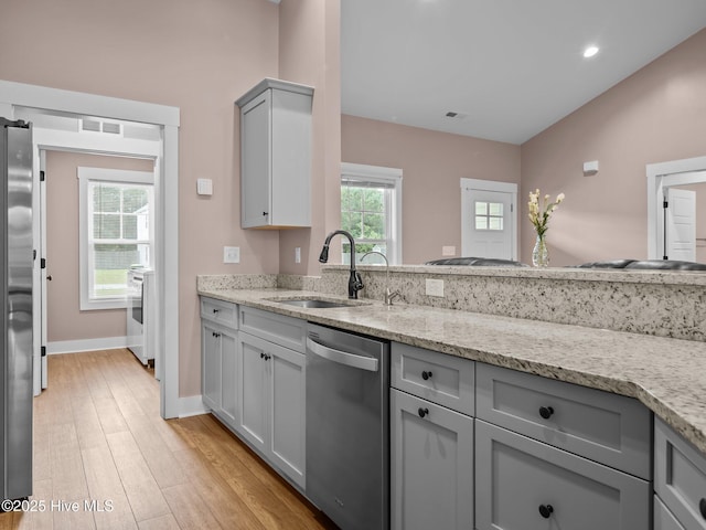 500 Perth Ct, Hubert, NC 28539 - kitchen featuring appliances with stainless steel finishes, gray cabinets, light stone counters, light wood finished floors, and recessed lighting