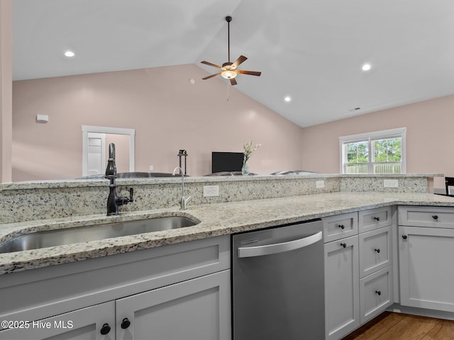 500 Perth Ct, Hubert, NC 28539 - kitchen with stainless steel dishwasher, a ceiling fan, vaulted ceiling, light stone counters, and wood finished floors
