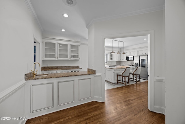 3902 Kipling Ct, Greenville, NC 27834 - kitchen with appliances with stainless steel finishes, crown molding, glass insert cabinets, white cabinets, and dark wood-style floors
