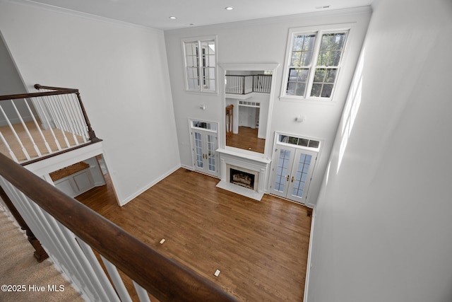 3902 Kipling Ct, Greenville, NC 27834 - unfurnished living room with a fireplace, wood finished floors, french doors, crown molding, and stairway
