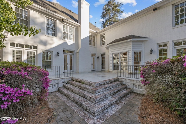 3902 Kipling Ct, Greenville, NC 27834 - property entrance with a chimney and french doors