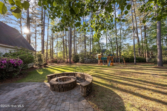 3902 Kipling Ct, Greenville, NC 27834 - view of grassy yard with a playground and an outdoor fire pit