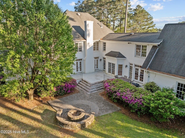 3902 Kipling Ct, Greenville, NC 27834 - back of house with french doors, an outdoor fire pit, a patio, and roof with shingles