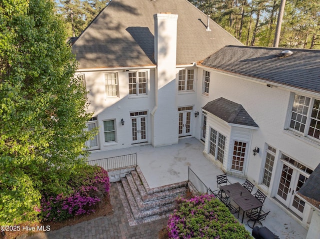 3902 Kipling Ct, Greenville, NC 27834 - rear view of property with french doors, a shingled roof, a patio, and a chimney