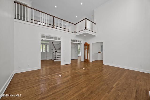 3902 Kipling Ct, Greenville, NC 27834 - unfurnished living room featuring stairway, a towering ceiling, recessed lighting, ornamental molding, and wood finished floors
