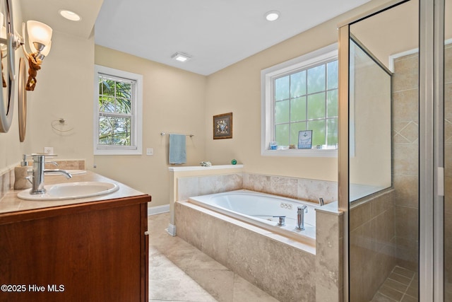 9406 Voyagers Way, Wilmington, NC 28412 - full bath featuring a bath, a stall shower, double vanity, and tile patterned floors
