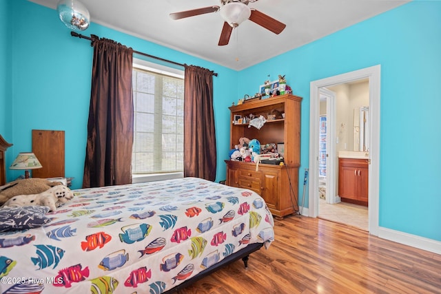 9406 Voyagers Way, Wilmington, NC 28412 - bedroom with light wood finished floors, connected bathroom, and ceiling fan