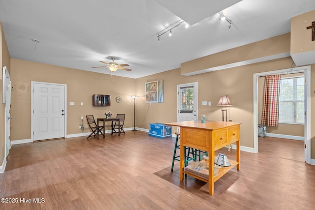 9406 Voyagers Way, Wilmington, NC 28412 - dining room featuring rail lighting, ceiling fan, and light wood finished floors
