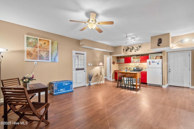 9406 Voyagers Way, Wilmington, NC 28412 - kitchen featuring freestanding refrigerator, light wood-style flooring, ceiling fan, and light countertops