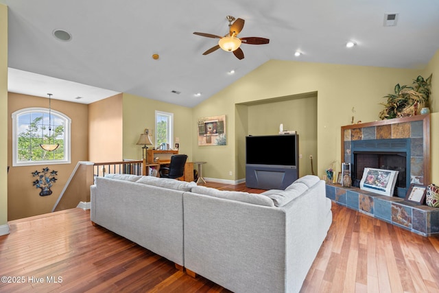 9406 Voyagers Way, Wilmington, NC 28412 - living area featuring ceiling fan, wood finished floors, a tiled fireplace, and lofted ceiling
