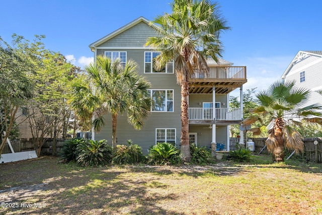 9406 Voyagers Way, Wilmington, NC 28412 - rear view of house with a balcony and a fenced backyard