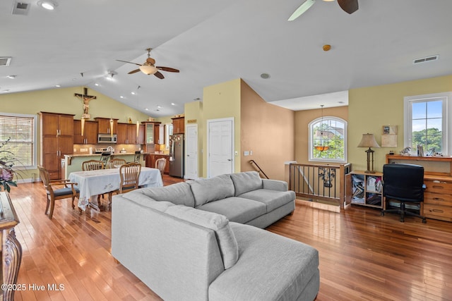 9406 Voyagers Way, Wilmington, NC 28412 - living area with a ceiling fan, light wood finished floors, lofted ceiling, and plenty of natural light