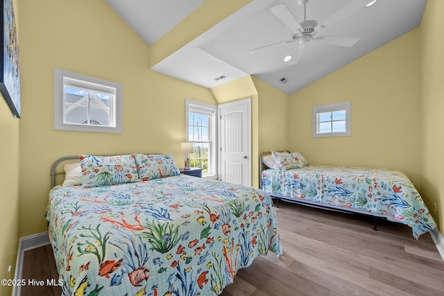 4340 Island Dr, North Topsail Beach, NC 28460 - bedroom featuring vaulted ceiling, multiple windows, wood finished floors, and a ceiling fan
