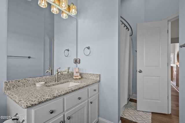 4340 Island Dr, North Topsail Beach, NC 28460 - bathroom with vanity, wood finished floors, and a chandelier