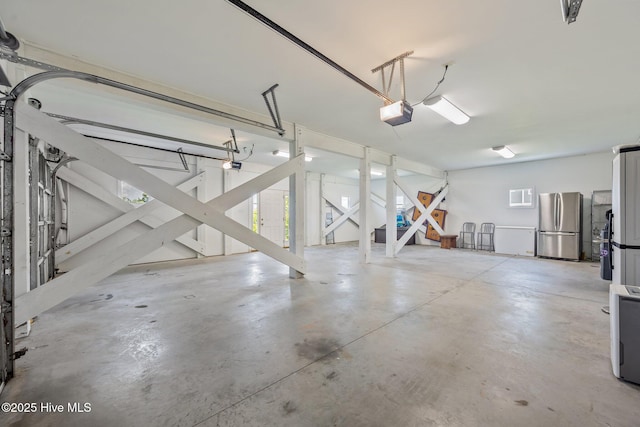 4340 Island Dr, North Topsail Beach, NC 28460 - garage with freestanding refrigerator and a garage door opener