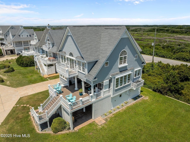 4340 Island Dr, North Topsail Beach, NC 28460 - rear view of property with stairs, roof with shingles, a deck, and a lawn
