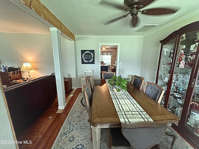 4321 Spearman Rd, Bolton, NC 28423 - dining area featuring crown molding, a ceiling fan, dark wood-style flooring, a textured ceiling, and decorative columns