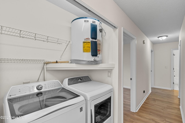 5601 W Chop Way, Wilmington, NC 28412 - laundry room featuring washer and dryer, water heater, light wood-type flooring, and a textured ceiling