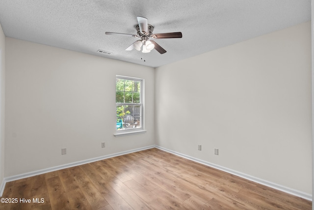 5601 W Chop Way, Wilmington, NC 28412 - empty room featuring wood finished floors, ceiling fan, and a textured ceiling