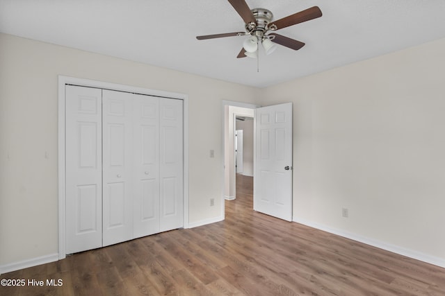 5601 W Chop Way, Wilmington, NC 28412 - unfurnished bedroom with wood finished floors, a closet, and ceiling fan