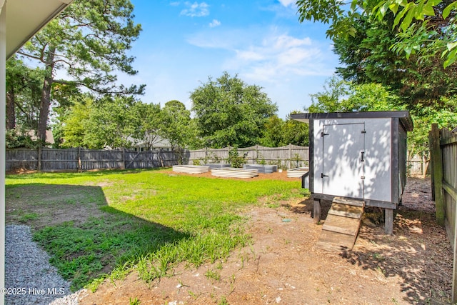 5601 W Chop Way, Wilmington, NC 28412 - fenced backyard with a garden and a storage unit