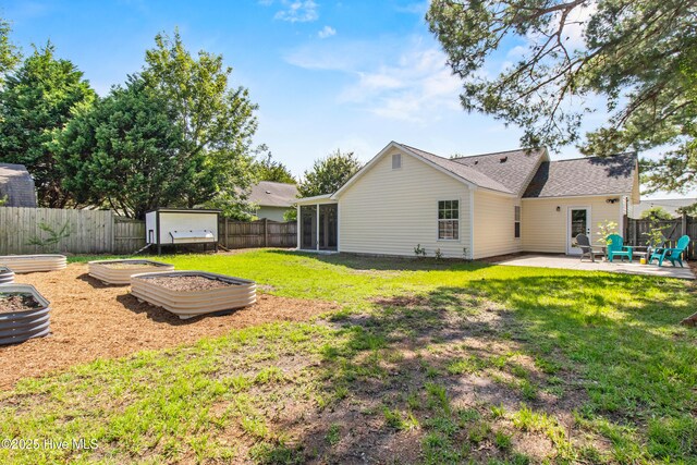 5601 W Chop Way, Wilmington, NC 28412 - fenced backyard featuring a vegetable garden and a patio