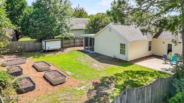 5601 W Chop Way, Wilmington, NC 28412 - fenced backyard with a sunroom, a garden, and a patio area