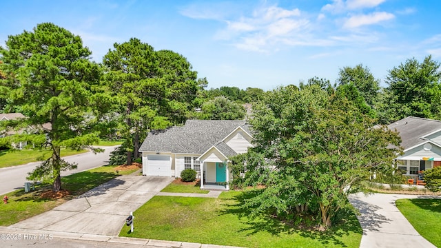 5601 W Chop Way, Wilmington, NC 28412 - view of property hidden behind natural elements with concrete driveway, a front yard, and a garage