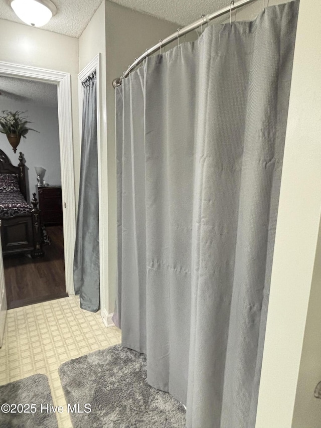 103 Jay Trl, Murfreesboro, NC 27855 - bathroom featuring a textured ceiling, ensuite bathroom, and a shower with curtain